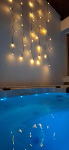 a group of lights hanging over a swimming pool at Apartman ARIA in Kutina