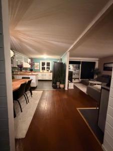 a kitchen and living room with a table and a couch at Recently renovated house in the heart of tromsdalen in Tromsø