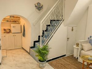 a staircase in a living room with a plant at Maison traditionnelle totalement privée au médina in Chefchaouene