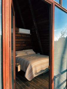 a bedroom with a bed inside of a glass door at Cabañas Hacienda de Letras in Pabellón de Arteaga +37 photos
