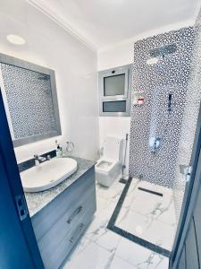 Un baño con ducha, lavabo e inodoro. en Legend Pyramids Inn, en El Cairo