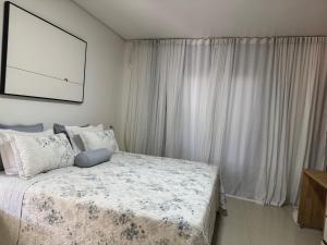 een slaapkamer met een bed en een groot raam bij Refúgio na natureza in Parauapebas