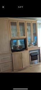 a tv sitting inside of a wooden cabinet at Woodlands Dene - Crimdon Dene Holiday Park - Accessible in Hartlepool