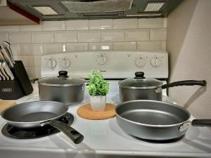 two pots and pans on a stove in a kitchen at Townhouse A plus location pool long stay discounts in Sherman