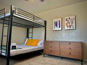 a bedroom with a bunk bed and a dresser at Townhouse A plus location pool long stay discounts in Sherman
