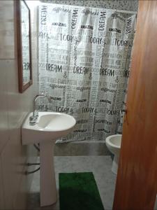 ein Badezimmer mit Waschbecken und Duschvorhang in der Unterkunft Duplex La Luna in Mar del Tuyú