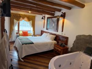 a bedroom with a bed and a bath tub at Hotel Maderanegra By Huasicama in Latacunga +44 photos