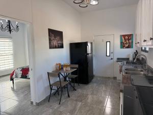 a kitchen with a small table and a black refrigerator at Ocean View Suite in Gated Community, Kino Bay MX in Bahía Kino