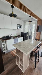 a kitchen with a marble counter top in a room at Departamento 2 dormitorios vista al lago in Villarrica +12 photos
