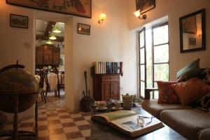 a living room with a couch and a table at Maison De L'Orb in Béziers