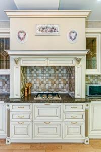 a kitchen with white cabinets and a stove at Mc Donalds Hotel Apartment Nizami Street in Baku +115 photos