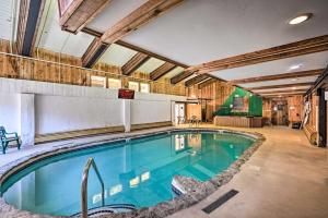 a swimming pool in a building with at 8 Mi to Mt Snow Cozy Bear Cabin with Hot Tub! in Wilmington