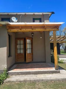a wooden pergola over the entrance to a house at Rest has name Sonko in Tafí del Valle +22 photos
