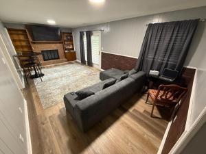 a living room with a couch and a table at Peaceful 4BR Haven in Stn Mtn GA in Stone Mountain