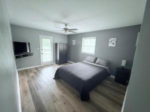 a bedroom with a bed and a ceiling fan at Peaceful 4BR Haven in Stn Mtn GA in Stone Mountain