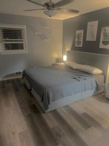 a bedroom with a bed and a ceiling fan at Peaceful 4BR Haven in Stn Mtn GA in Stone Mountain