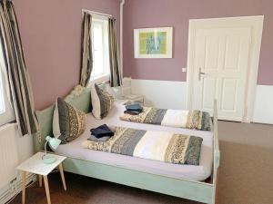 Ferienwohnung und Pension Goldberg في غروسشوناو: غرفة نوم بسريرين عليها مخدات