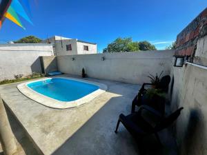 a swimming pool on a patio next to a wall at Casa Guemes in Victoria