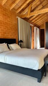 a bedroom with a large bed in a room at Aerys Village in Somone