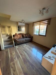 a living room with a couch and a table at Alojamiento casa in Temuco