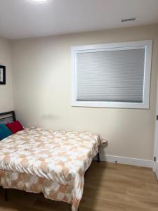 Un dormitorio con una cama frente a una ventana. en Isabella's Dome, en Hammonds Plains