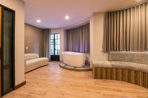 a living room with a tub and a couch at CasaSue Living & Hotel in Bogotá