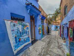 a street in the blue city of chefchaouen with painted buildings at Chambre Lumineuse avec Vue Ruelle Bleue et Terrasse in Chefchaouene +26 photos
