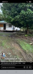 a picture of a house with a tree and a dirt road at Casita colibri in Savegre