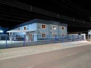 a building on the side of a street at night at Pousada Bella Pantano in Pântano Grande