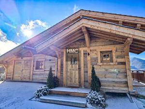 een blokhut met een voordeur in de sneeuw bij Chalet Bliss Jacuzzi vue in Bolquere Pyrenees 2000