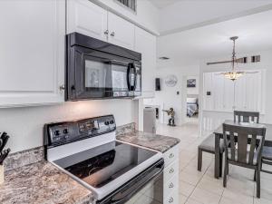 a kitchen with a stove and a microwave at Adventure House RRYC17 in Rockport