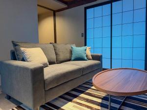 a living room with a couch and a table at SORAIRO Miyajima in Hatsukaichi +57 photos