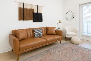 a brown leather couch in a living room at Worker friendly A plus Location Warm and Cozy in Sherman