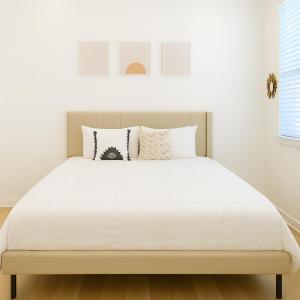 a bedroom with a bed with white sheets and pillows at Worker friendly A plus Location Warm and Cozy in Sherman +16 photos