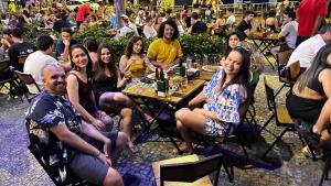 a group of people sitting at a table in a restaurant at Nuhh Hostel & Café in Belo Horizonte +178 photos