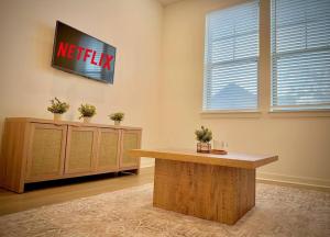 a meeting room with a television on a wall at WorkerFriendly KINGbed A plus Location Washer Wifi Pool in Sherman