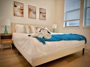 a bedroom with a bed with towels on it at WorkerFriendly KINGbed A plus Location Washer Wifi Pool in Sherman