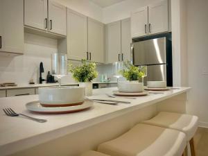 a kitchen with white cabinets and a white counter top at WorkerFriendly KINGbed A plus Location Washer Wifi Pool in Sherman +13 photos