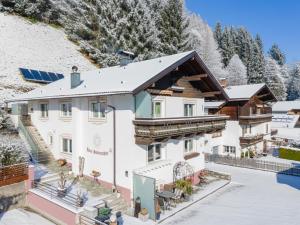 a house in the mountains with snow on the ground at Sonnenschein I in Stuhlfelden