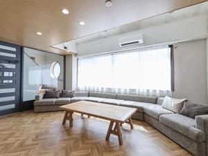 a living room with a couch and a table at LIVE HEART House in Nara