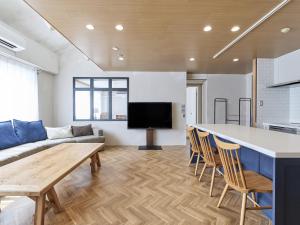 a living room with a couch and a table at LIVE HEART House in Nara