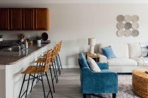 a living room with a bar with chairs and a couch at Spacious 3 Bed Condo Near ETSU in Johnson City