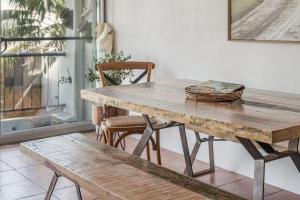 a wooden table and bench in a room at Wintersview 3 in Lennox Head
