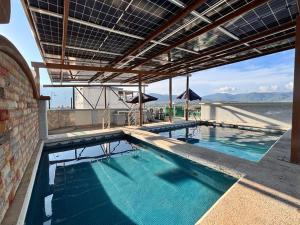 an indoor swimming pool with a view of the ocean at Grand Hotel Iguala in Iguala de la Independencia