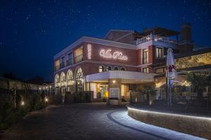 a building with a sign on it at night at Villa Plaza Boutique Hotel & Spa in Prešov