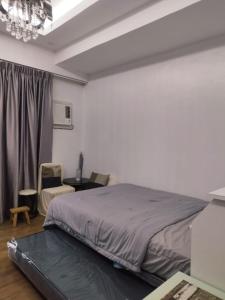 Una cama o camas en una habitación de 517 Grand Amani Mactan, Lapu-Lapu City, Cebu 15 fotos más