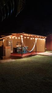 a house with lights on the side of it at night at Arai Apart Iguazu in Puerto Iguazú +1 photo