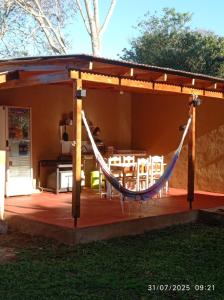 a pavilion with a hammock on a patio at Arai Apart Iguazu in Puerto Iguazú