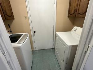 a small bathroom with a sink and a washing machine at NEW Grand Escape For Large Families and Groups in Garland