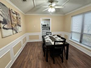 a dining room with a table and a ceiling fan at NEW Grand Escape For Large Families and Groups in Garland +20 photos